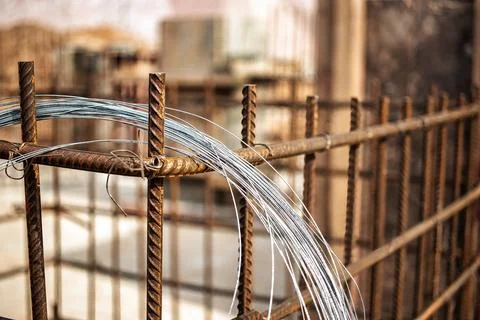 Workers are constructing a reinforced concrete foundation with steel bars and Stock Photos