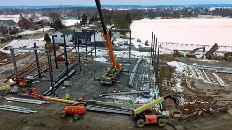 Workers are constructing a steel structure in a cold location close to a frozen Stock Footage 331700765
