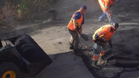 Workers are doing road repair on the outskirts of Kiev Stock Footage 120401280