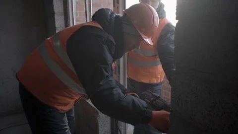Workers are engaged in installation of a plastic window Stock Footage 82304865