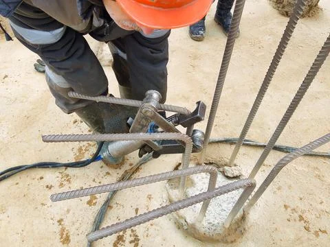 Workers are engaged in preparing a pile foundation at an industrial construct Stock Photos