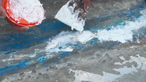 Workers are fixing cracks in the floor, spreading plaster using trowel, Repairin 스톡 동영상 207842363