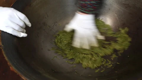 Workers are frying tea by hand Stock Footage 137316336