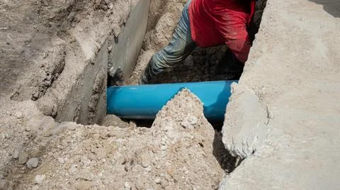 Workers are installing PVC pipes. Stock Photos