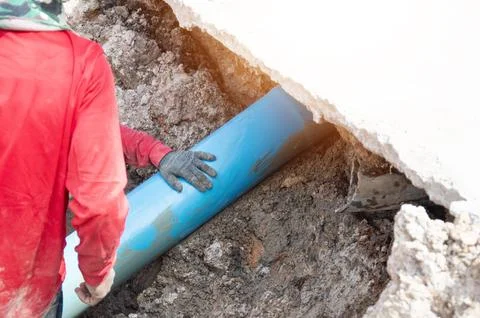 Workers are installing PVC pipes. Stock Photos