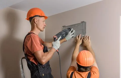 Workers are installing a split system for a air condition. Stock Photos