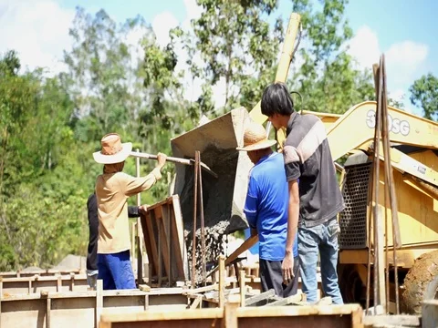 Workers are leveling cement with tractor Stock Footage 103917547