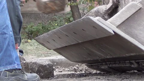 Workers are loading granite stones from the road surface into the excavator 스톡 동영상 148815110