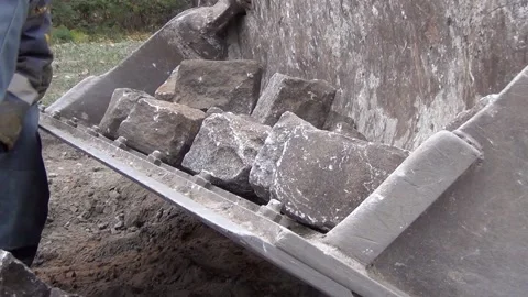 Workers are loading granite stones from the road surface into the excavator 스톡 동영상 148815689