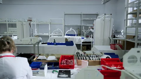 Workers are manually assembling the surgical lights at a manufacturing workplace Stock Footage 170960465