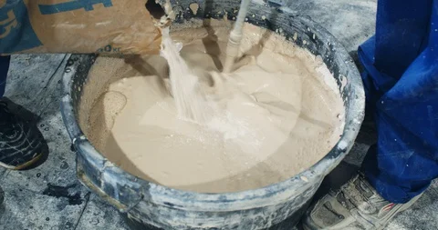 Workers are mixing the plaster in the bucket during the renovation work, 4k Stock-Footage 129427626