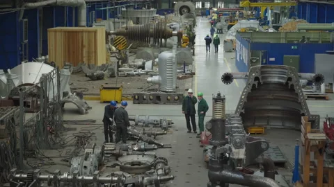 Workers are moving and preparing equipment to buid a new steam turbine at plant Stock-Footage 219879993