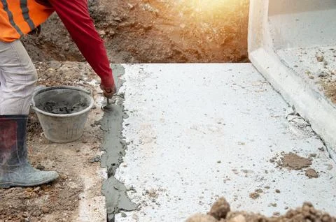 Workers are plastering the construction area. Stock Photos