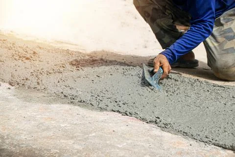 Workers are plastering at the construction site. Stock Photos