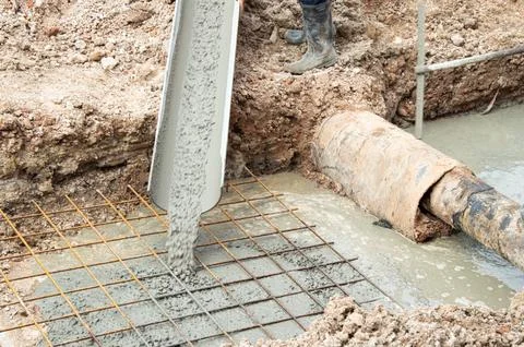 Workers are pouring cement on the construction site. Stock Photos