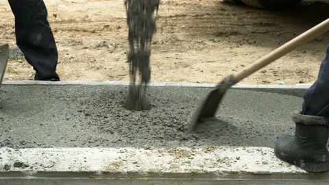 Workers are pouring concrete into the formwork. Stock Footage 164674735