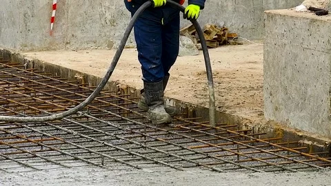 Workers are pouring structural concrete at a construction site Stock Footage 310045219