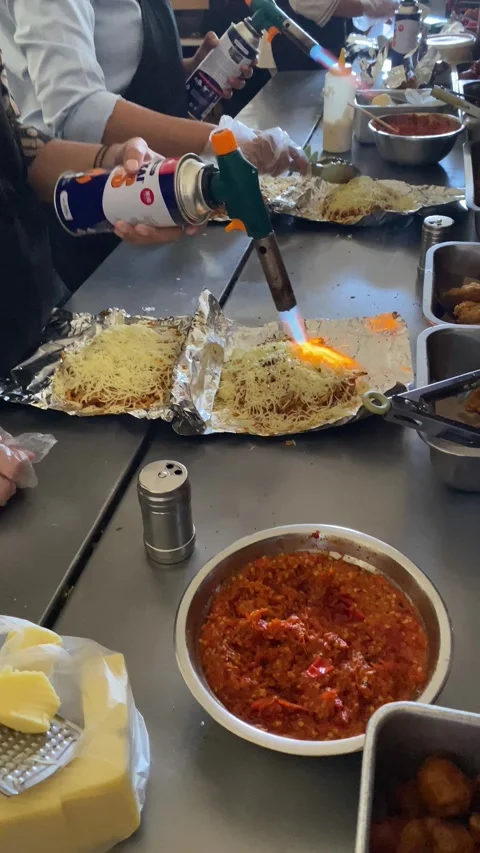 Workers are preparing food called "mie bakar" or roasted noodles Stock Footage 293039426