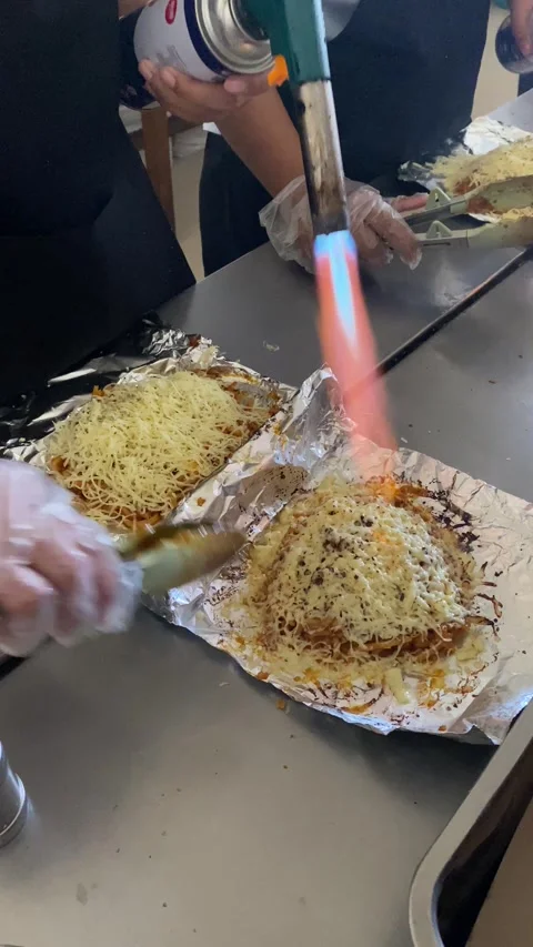 Workers are preparing food called "mie bakar" or roasted noodles Stock Footage 293039494