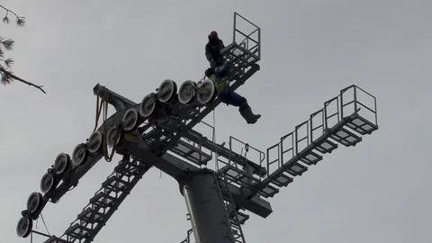 Workers are preparing to perform installation work on  of cable car support Stock Footage 106799499