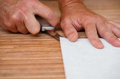 Workers are preparing wallpaper for hanging. Stock Photos