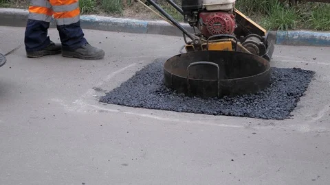 The workers are pulling out the molding ring and setting the well cover Stock Footage 108063207