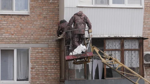 Workers are repairing the balcony of a multi-storey apartment Stock Footage 255576835