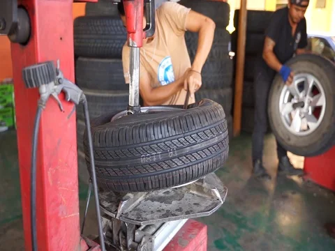 Workers are replacement the tire Stock Footage 105023566