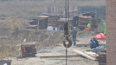 Workers are resting. lunch break at a construction site.  crane hook. Stock-Footage 120674547