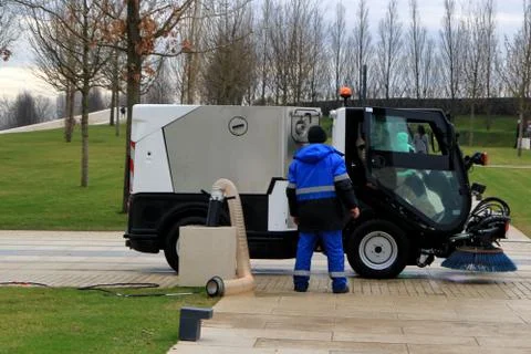 Workers are running a sweeper. Stock Photos