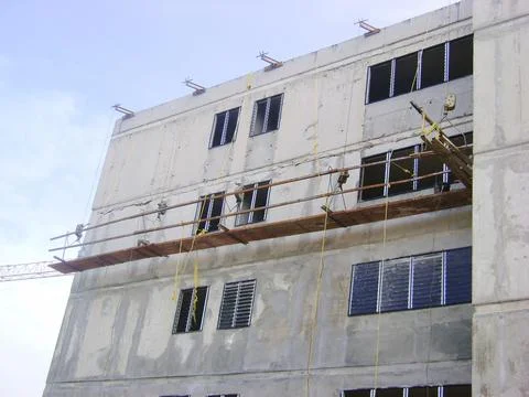 Workers are seen using scaffolding to construct a building in Venezuela under Photos