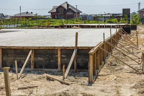Workers are setting up a concrete foundation for a residential project in a.. 写真素材