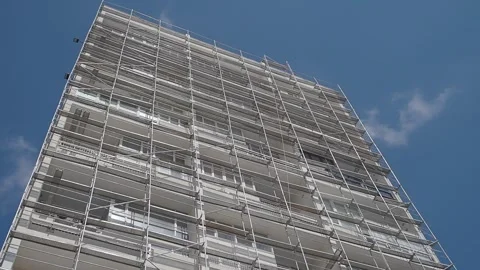 Workers are setting up scaffolding on a building Stock Footage 344917181