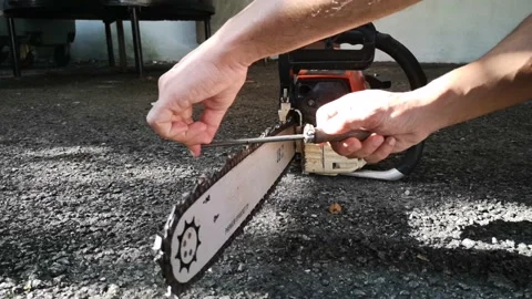 Workers are sharpening chainsaws manually. Stock Footage 148981425