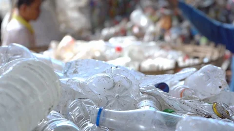 Workers are sorting out plastic bottles to recycle into new bottles. Stock Footage 111573476