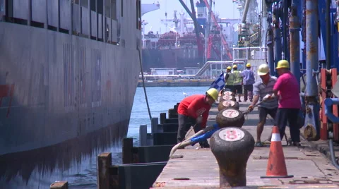 Workers are tying a container ship. Mooring operation in Kaohsiung Port Stock Footage 66448359