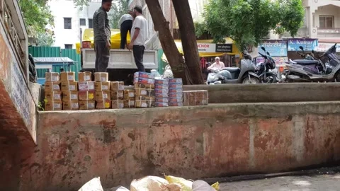 Workers are unloading the goods from the pickup trucks in India - Stock Footage 255874093