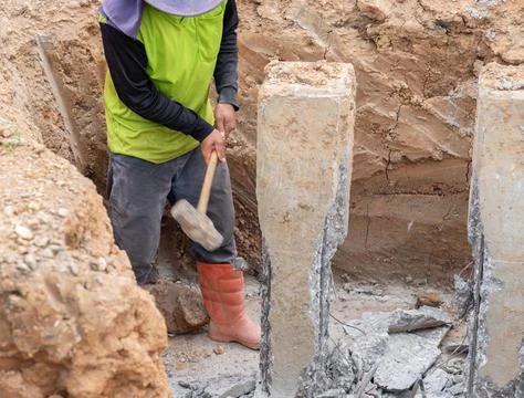 The workers are using hammers to break the pile heads. 写真素材