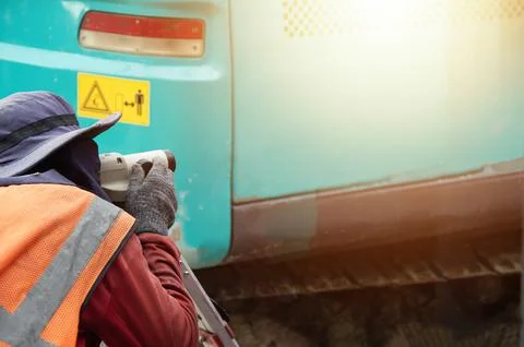 Workers are using a level measuring camera at a construction site. Stock Photos