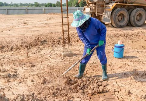 Workers are using a shovel to adjust surface soil. Stock Photos
