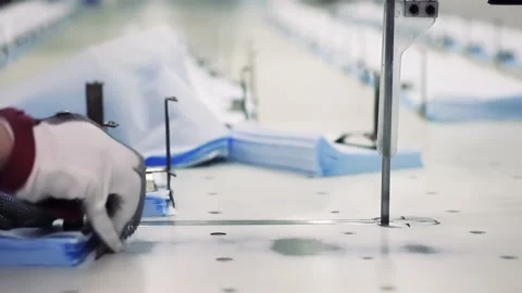 Workers are using tools to cut medical masks in their entirety Vídeos de archivo 130938794