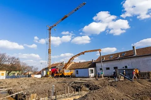 Workers are working on concreting at construction site. Stock Photos