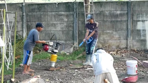 Workers are working to level the ground to turn the garden into a park Stock Footage 157136797