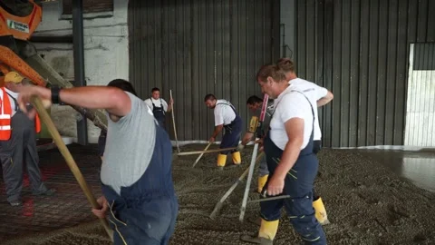 Workers arranging concrete poured by a machine 動画素材 152879939