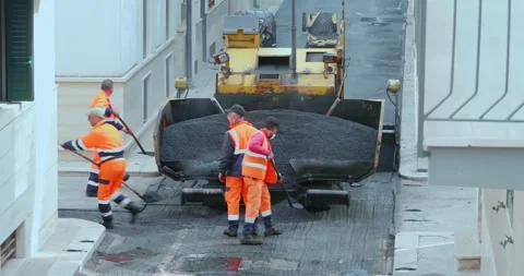 Workers with an asphalt machine during asphalt resurfacing work in the city s Stock-Footage 247626546