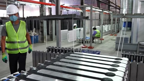 Workers assemble battery parts. 動画素材 310740676