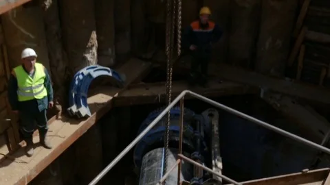 Workers assemble large plastic sewer pipe PEX ready for installation with specia Stock Footage 81917430