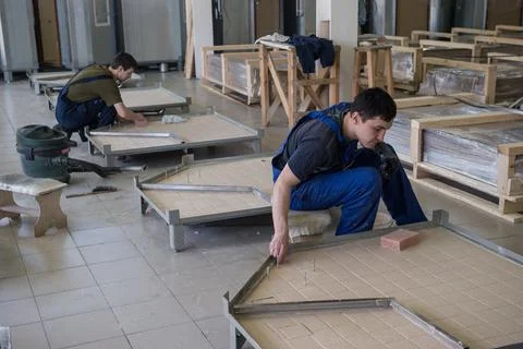 Workers assemble shower cabins ship Stock Photos