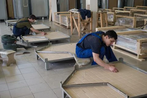 Workers assemble shower cabins ship Stock Photos