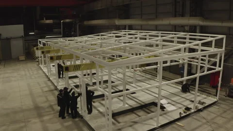 Workers assemble steel canopy using heavy metal beams Video stock 304414390